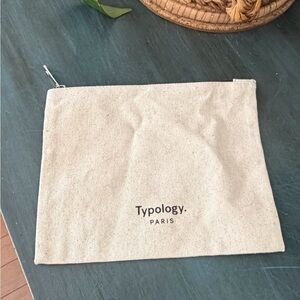 Typology minimalist zipper toiletry bag made of recycled cotton in cream color.